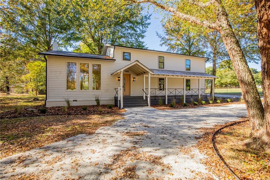 Welcome to the Wyman River house, a beautifully remodeled home by Nall Custom Homes and ReJennaRation. The finishes are unique but classic, the interior spacious but cozy and the 2.34 acre lot with a view is perfect for a family seeking seclusion and beauty atop the White River. The home has all new siding, windows, and roofing. The interior has wide plank Core Tec LVP flooring, Fabuwood dovetail cabinetry and quartz counters. Custom iron railings inside and out, white oak fireplace, new water heaters and plumbing fixtures throughout. Designer lighting, 3 custom tiled showers, new Frigidaire appliances and beverage fridge. Functional floor plan features a large master en-suite on first floor with laundry access as well as powder bath with an antique door downstairs. Upstairs features 4 additional bedrooms and 2 full baths each with dual sinks plus a loft that would make the perfect reading studio or office. Zoned for East Fayetteville schools! Space, function, style, location...it has it all!