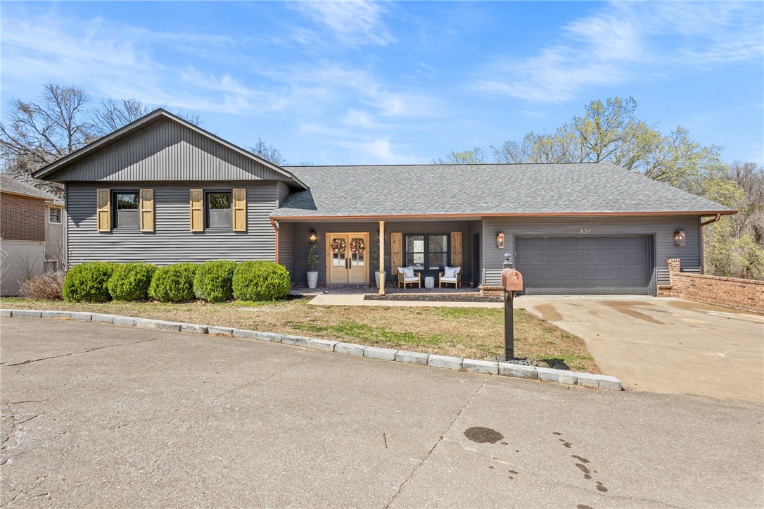 Just minutes from downtown Rogers, Beaver Lake, and across from Lake Atalanta, this spacious 4 bedroom, 3.5 bathroom home is located on a private cul-de-sec. The chef’s kitchen features a 48" gas range, an 11' island, new appliances including a ZLINE microwave drawer and is bathed in natural light from large windows. The master bedroom has its own fireplace, two large closets, and ensuite offering a secluded retreat. This home offers a walkout basement with a separate entrance, bedroom, bathroom, and kitchen—perfect for rental income or a mother-in-law suite. All new flooring, interior and exterior paint, cabinets, vanities, showers, tubs, countertops, appliances, closet finishes, lighting, fixtures and more with newer roof and windows. The adjacent .43-acre lot is available separately. Agent owned.