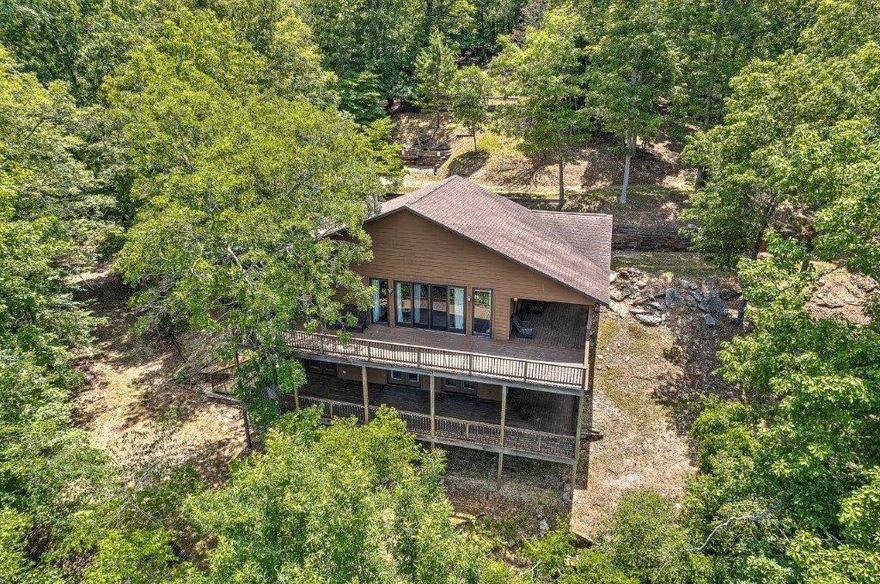 Very nice private Beaver Lake lake front retreat on 9.75 acres. Year-round lake view. Private boat dock, over 400' of lake frontage. 3264 SF, 3 bed, 2.5 bath. Completely remodeled. Large shop with 3/4 bathroom for all your toys. Cleaned and leveled pad for another home or shop.