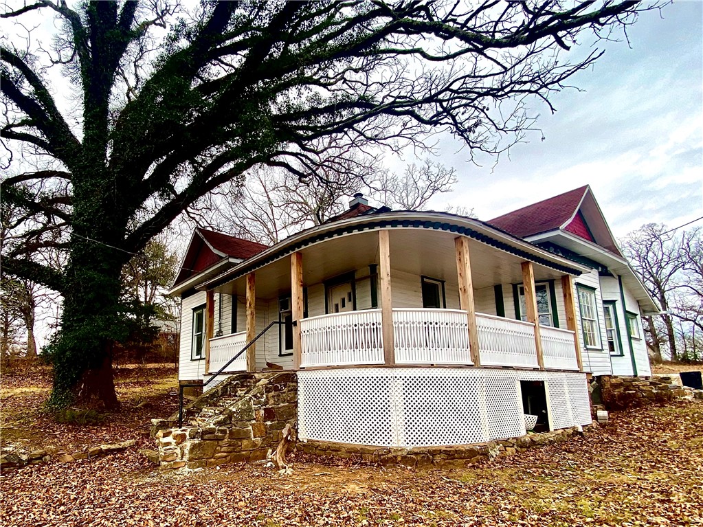 Historic charm meets modern updates in this beautifully remodeled 3-bed, 2-bath post-Victorian home in Winslow, AR. Situated on an oversized corner lot with mature trees, On the hill between this home offers tranquility & convenience near Hwy 71. This home boasts numerous 2024 updates including new plumbing and fixtures, new wiring and panel, two mini-split heat pumps, refinished hardwood floors, new interior and exterior paint, a new porch and railing, new cabinets, and soaring 10ft ceilings in the dining and living areas. Inside you will find three bedrooms, two bathrooms, spacious living and dining areas, and an updated kitchen. The exterior features an oversized lot with mature trees surrounding the covered wrap-around porch boasting amazing views. Positioned between (2) churches this gem blends historic character with modern living and a chance to own a Winslow, AR original. With the farmers market, Winfest, and easy access to NWA this property provides a quintessential, small-town Arkansas living experience!