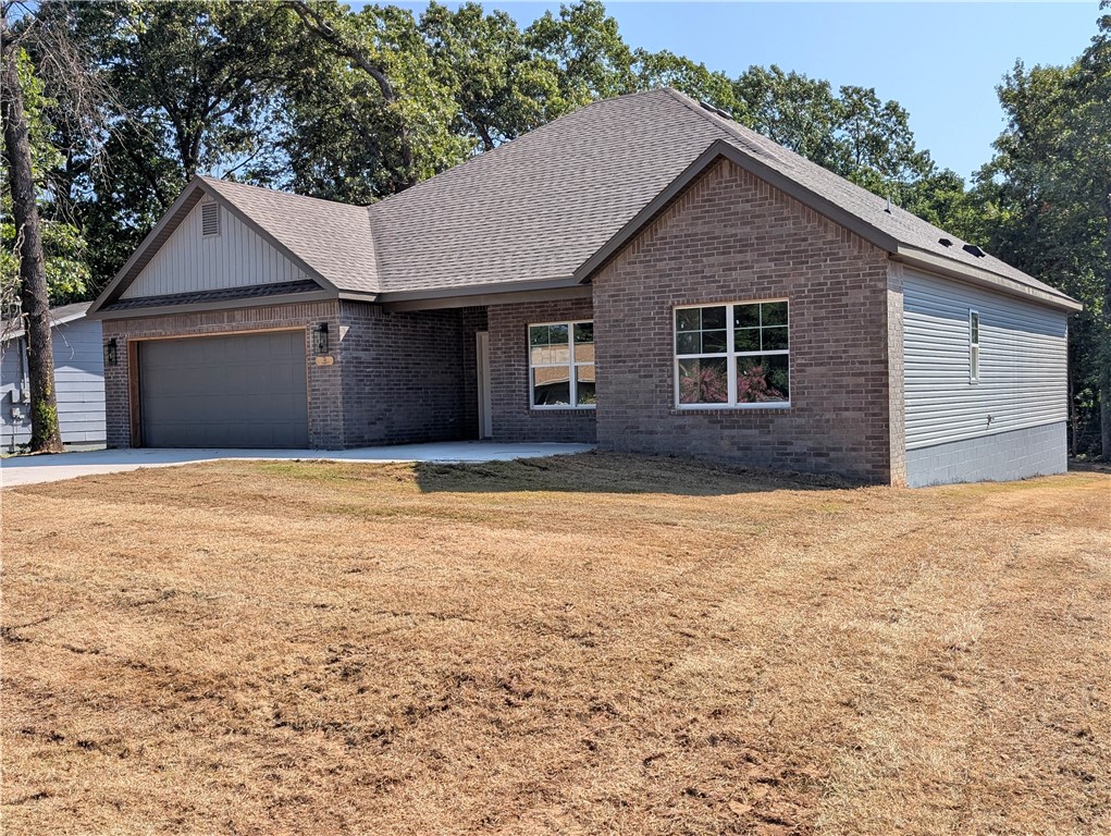 Welcome to your charming new retreat in beautiful Bella Vista! This inviting 3-bedroom, 2-bath home boasts a low-maintenance Brick and Vinyl exterior and is perfectly designed for comfort and style. Step inside to discover all-tile flooring throughout, offering durability and easy upkeep, complemented by a stunning accent wall in the cozy breakfast nook — the perfect spot to start your day. Enjoy quiet mornings or relaxing evenings on the peaceful porch, set on a spacious wooden deck overlooking the natural beauty that surrounds you. This home combines modern convenience with serene living — a true gem in Bella Vista!