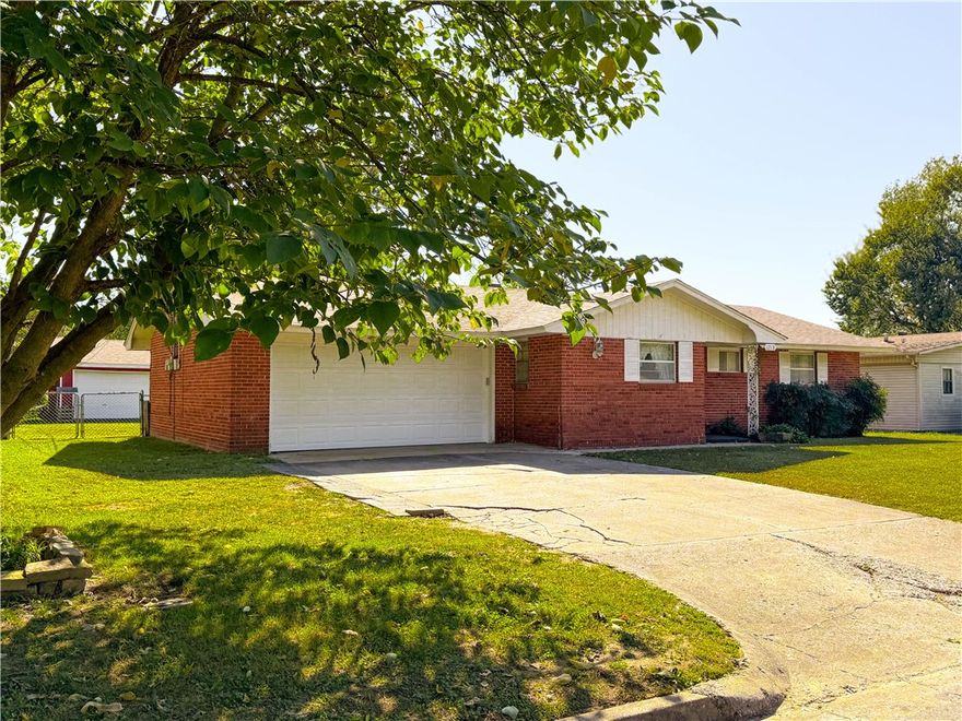 Looking for a solid mid-century home with an extra 2 car garage and shop located right in your backyard - look no further!  This well loved home is located in the heart of Springdale. Close to schools, shopping and I49.  All brick home with new roof and heat/air.  Screened in porch for summer fun and extra large fenced in backyard.