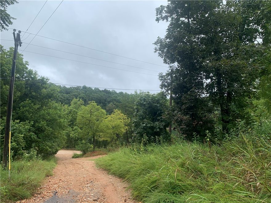 Motivated Seller!! Packed with potential! Discover 4.74 acres of opportunity with lake view and a convenient public boat launch just across the street! This property is ready for your vision, whether you're looking to build your dream home or create a private retreat. Land is fully useable with several flat buildable areas. Key features: Septic, public water, and electric already available, 30x32 insulated metal garage building, and 4 RV hookups for guest or family gatherings. The manufactured home conveys with property in "as is" condition. Don't miss your chance - come take a look and bring us an offer!