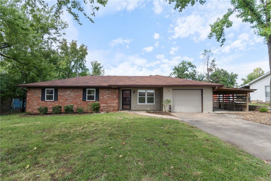 Location, lifestyle, and thoughtful updates — this Bentonville gem has it all. Just minutes by foot or bike to the new Walmart campus, The Momentary, 8th Street Market, and downtown events, this home offers the best of convenience and comfort. Inside, enjoy granite countertops throughout, new appliances, spacious rooms, and generous storage. The primary suite includes a walk-in closet and full en suite bath. A 200 sq. ft. sunroom opens to a covered patio and a beautifully designed stone fire pit area—ideal for relaxing or entertaining. The home also features a shed, garage, and additional carport. Recent renovations include fresh paint, new carpet, wood-look tile flooring, and an open-concept layout with a stylish bar connecting the dining and living spaces. Updated lighting, kitchen, and bathrooms add the final touches. This is a rare opportunity to own a fully updated home in an unbeatable location—where Bentonville’s best amenities are just outside your door.