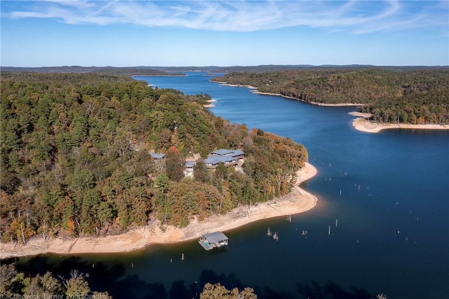 Gorgeous lakefront home, expansive views of Beaver Lake & Hobbs State Park. Over 1000 sqft of shoreline private boat dock 2 boat slips & swim dock. Enjoy the natural beauty outside on the 3167 sqft wraparound deck with outside living area. Panaramic deck views are unspoiled Hobbs State Park land creating a naturally pristine scene with no other homes or boat dock visible. 2012 the entire home was renovated & architecturally remodeled with large addition completed by Brya architects. The artistic stonework throughout is a showstopper and complements the natural landscape & rock walls. The home features two oversized living rooms with vaulted wood ceilings and beautiful woodwork that extends to the outside. The 5 bedroom home with current set up comfortably sleeps 17. Gourmet kitchen features quartz countertops, large center island, double ovens, refrigerator drawers, ice maker & gas cooktop. Private office with beautiful custom woodwork & cabinetry. Lake views from almost every room in the home.