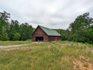 Own the last house before the Buffalo National River with this beautiful home built in 2008 with 20' cathedral ceiling in living room with wall of glass facing East. Rustic home has cedar ext siding with int having tongue & groove yellow pine on ceiling, walls, floors & cabinets. Awesome views abound from upstairs & deck off living room. Kitchen features 1 piece commercial SS sink with running boards, deep freeze hidden in island & near new side by side refrigerator. Garage has a floor drain & SS sink. Land has much uncut oak, hickory & pine, & year round spring (per owner). Very energy efficient with spray foam insulation & wood stove to help keep the utility costs down. 1 mile from Buffalo National River Park Service land & 1 3/4 miles to the Maumee North Boat Launch.