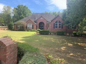 CLASSIC ELEGANCE abounds in this beautiful 3 BR, 2 1/2 BA brick home on a large corner lot in one of Russellville's most well-established neighborhoods. The spacious, double door entry opens to the lovely formal living and dining room. Large kitchen features built-in desk and shelving, glass display cabinets and bar seating open to the breakfast area and comfortable den with gas fireplace. Side entry door from the driveway allows easy access for guests. Master BR opens into the master BA with double vanity, garden tub, separate shower/toilet area and a large walk-in closet. On the back of the house the enclosed porch has a view of and easy access to the patio. Excellent storage throughout. The triple garage has easily accessible built-in storage. Great floor plan! Must see!