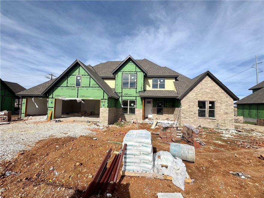 Walk to the community pool or skip across the street to the Razorback Greenway! This new construction, 5-bedroom home is bursting with curb appeal and includes an oversized 3 car garage with the third bay deep enough for any of your toys or for extra storage. Hang out in the living room with an impressive 20-foot soaring ceiling and open to the kitchen and dining area. The primary bathroom feels like a spa with two shower heads and a bathtub in a dedicated wet area with a linear drain.  Some other features include 3 cm quartz counter tops throughout, custom cabinets with soft close drawers/doors, Frigidaire Gallery appliances (cooktop vented to the exterior, & wall oven/microwave), custom powder coated handrails on the stairs, tiled shower surrounds in the other two bathrooms, custom mirror frames, low-e windows, fence, blinds, gutters, & an irrigation system.  Did I mention you can pick colors if they're available. We have some preferred lender incentives with local lenders up to $5,000 as well.
