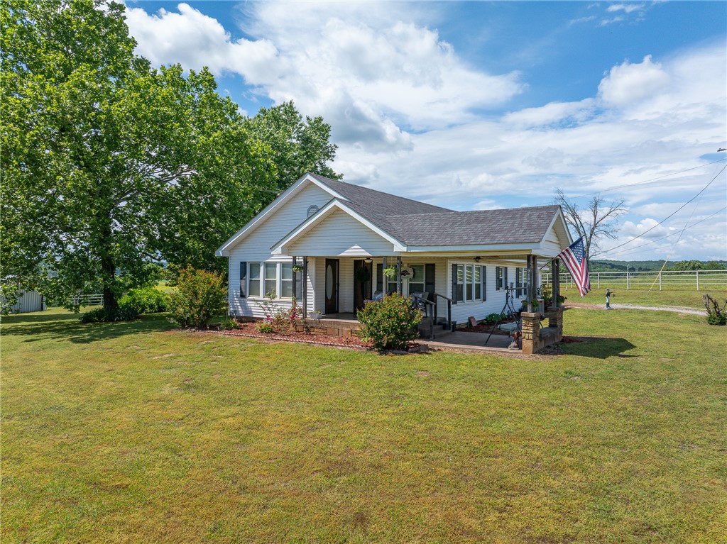 Charming Farmhouse w/3b/1ba on 30 Acres +/- of Scenic Pastureland! Great for livestock, or simply soaking in the peace of country living. Inside, you'll find a warm, inviting layout with ample cabinet space & a cozy, functional design. Step outside to a gardener’s paradise with a great garden spot, vibrant flowers, & plenty of wildlife. The land is fully fenced & cross-fenced, ready for animals, & includes a large hay barn, small hay barn, & a shop with dirt floor and electric. A corral is in place for easy livestock handling. An outdoor office with electric offers a great space to work from home while enjoying nature The back patio features a pergola & space to grill—just bring your own! Enjoy a large pond with a fishing dock, plus a smaller wet-weather pond. Three outdoor spigots use well water for gardening and livestock. The home is on public water and septic. Whether you're seeking a full-time residence, hobby farm, or weekend retreat, this property offers room to grow, explore, and enjoy. SOLD AS IS.