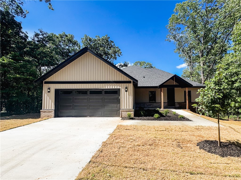 Nestled in a quiet, country-like setting, this 1,865 sq ft home offers 3 bedrooms, 2 baths, and a versatile bonus room or office—perfect for your lifestyle needs. Thoughtfully designed with ample storage throughout, it features quartz countertops, an electric fireplace, and a covered back deck ideal for relaxing or entertaining. The gently sloped driveway leads to a gently sloped yard surrounded by mature hardwoods with professional landscaping. Located in the Bentonville School District with abundant Bella Vista trails nearby, this home offers the perfect blend of comfort, convenience, and natural beauty.