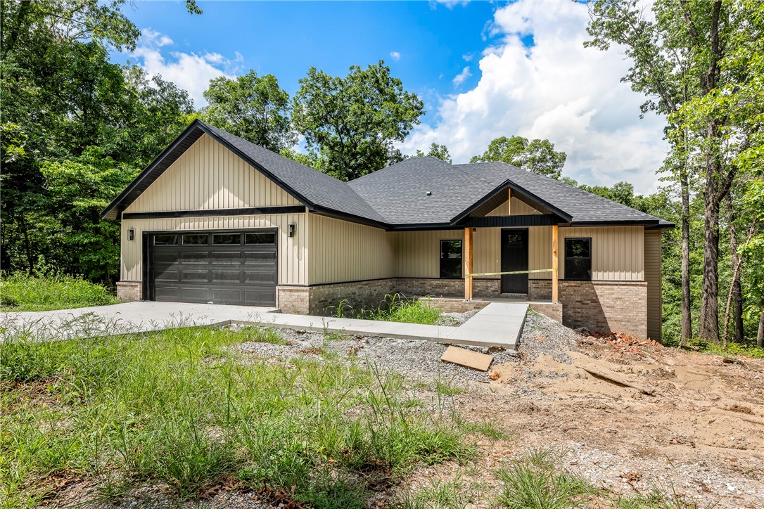 Nestled in a quiet, country-like setting, this 1,865 sq ft home offers 3 bedrooms, 2 baths, and a versatile bonus room or officeāperfect for your lifestyle needs. Thoughtfully designed with ample storage throughout, it features quartz countertops, an electric fireplace, and a covered back deck ideal for relaxing or entertaining. The gently sloped driveway leads to a gently sloped yard surrounded by mature hardwoods with professional landscaping scheduled for completion in July 2025. Located in the Bentonville School District with abundant Bella Vista trails nearby, this home offers the perfect blend of comfort, convenience, and natural beauty.