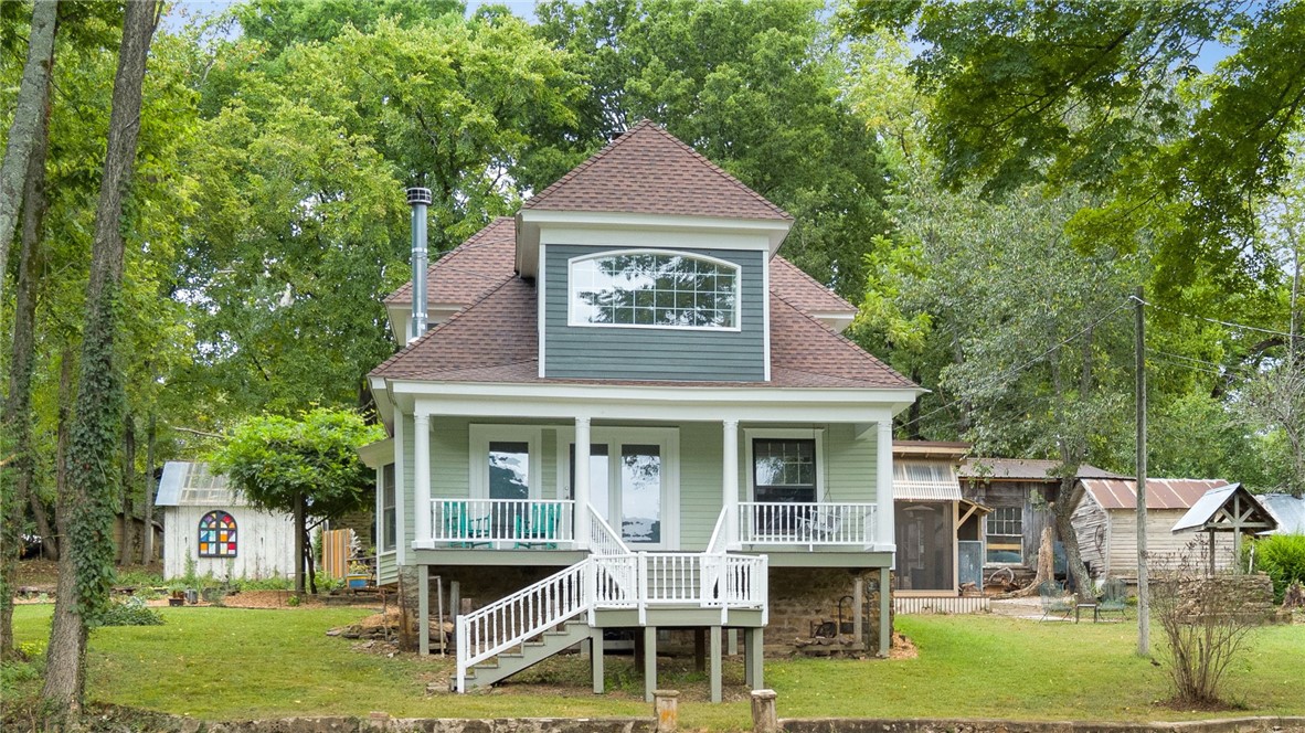 Looking for a home that’s as full of character as it is full of life? This 4.32-acre property is more than a place to live—it’s a place to create, grow, and play.
Inside this 2,305 sq. ft. home, you’ll find warm pine tongue-and-groove floors, restored wavy-glass windows, and the kind of craftsmanship you don’t see anymore. The fireplace in the living room and second fireplace in the screened in porch make every season cozy. Radiant heat in the kitchen floors. A queen Murphy bed makes space for guests while still leaving room for an office or craft room. You will love the stunning views from the front porch! Wildlife is part of daily life here.
The 1,000 sq. ft. wood shop has thoughtful reclaimed touches. There’s also a rebuilt garage/carport, a children’s treehouse with zip line, a 20-hen chicken house, a waterfall feature and don't forget the screened-in porch perfect for beautiful morning sunrises.
You’ll love the thoughtful upgrades: 2025 new roof, driveway re-graded w/ fresh gravel and new dormers.
