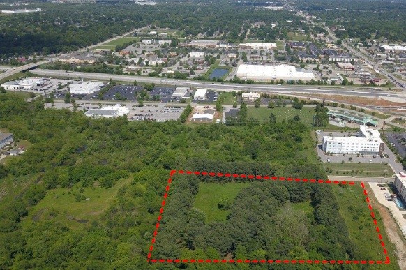 6.70 +/- acre commercial tract located within 1/4 mile from I-49. Surrounded by development, 2 major hotels located adjacent to property. Many potential uses. City utilities available. Natural pine tree perimeter and privacy. Be a great site for an Upscale Resort Hotel or a premier office complex.