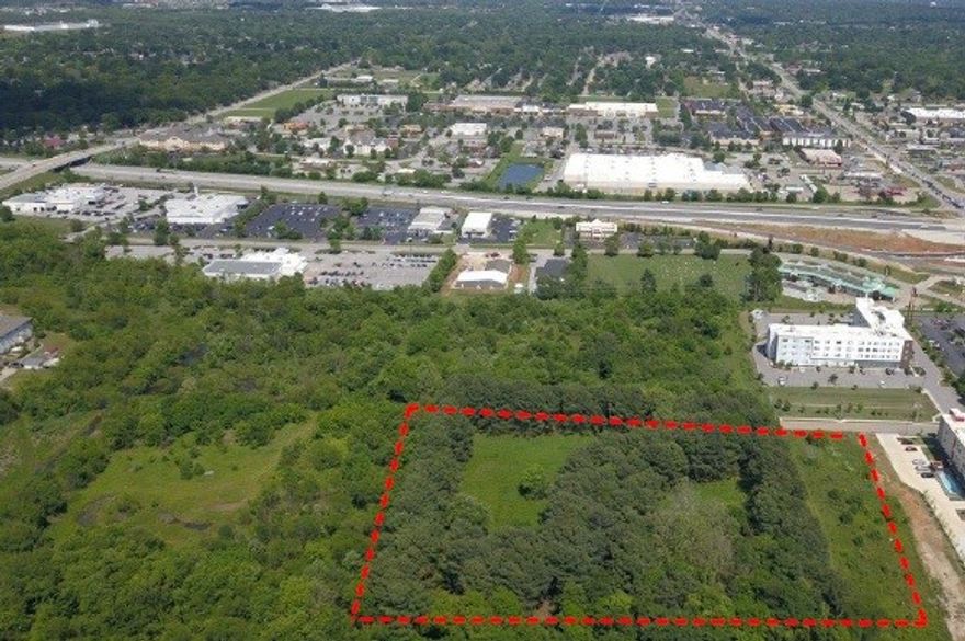 6.70 +/- acre commercial tract located within 1/4 mile from I-49. Surrounded by development, 2 major hotels located adjacent to property. Many potential uses. City utilities available. Natural pine tree perimeter and privacy. Be a great site for an Upscale Resort Hotel or a premier office complex.