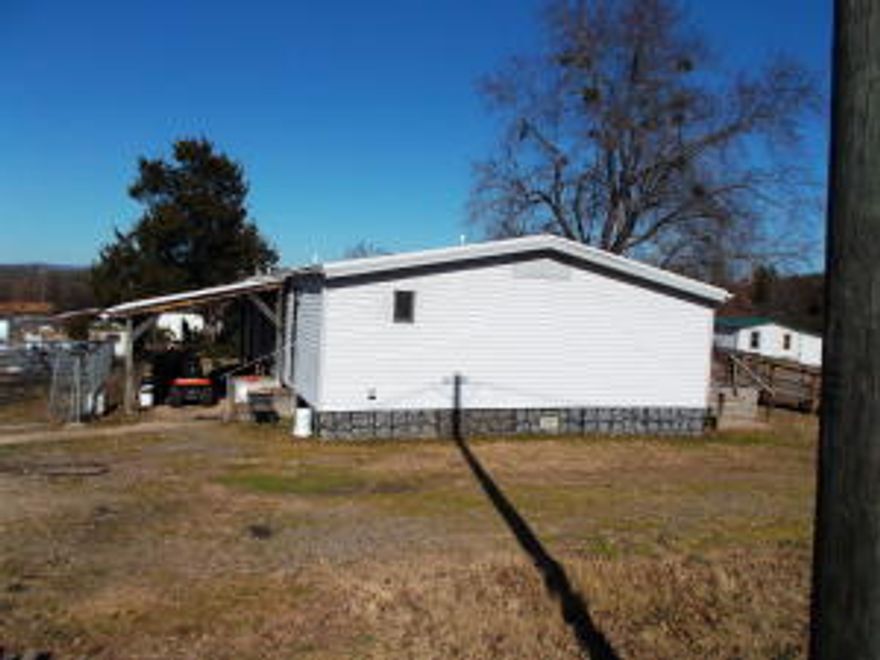 3 bedroom 2 bath Doublewide Mobile in very good shape. Has metal roof and covered patio. Also includes 30 x 40 metal shop with concrete floorwith heat & air. Nice Location close to town and spadra park