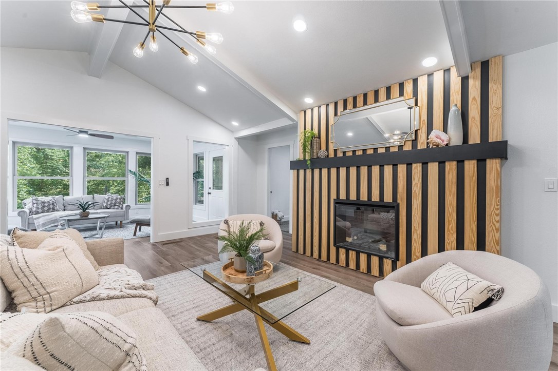 This stunner sits on a 0.33-acre lot and is 2 blocks from Tunnel Vision Trail. Step inside to find a redesigned fireplace with electric logs for year-round enjoyment, all new luxury vinyl plank flooring, new carpet, modern cabinets, lighting, fixtures, and paint throughout. A spacious living room with exposed wood beams flows seamlessly into a bright sunroom, which opens onto a large deck, perfect for entertaining. All bedrooms feature direct access to the deck for morning coffee or evening relaxation. The kitchen shines with new appliances, a pantry, and stylish gold accents paired with sleek black hardware, adding a designer touch to every room. Upgrades you’ll love: New HVAC system, sliding glass doors, Temperature-sensitive kitchen faucet, spa-like primary bath with rain shower, 6 body jets, LED lights, and a light-up makeup mirror. Backyard with a mix of shaded and open space for pets, play, or gatherings. This home is move-in ready with all the extras you didn't realize you needed.
