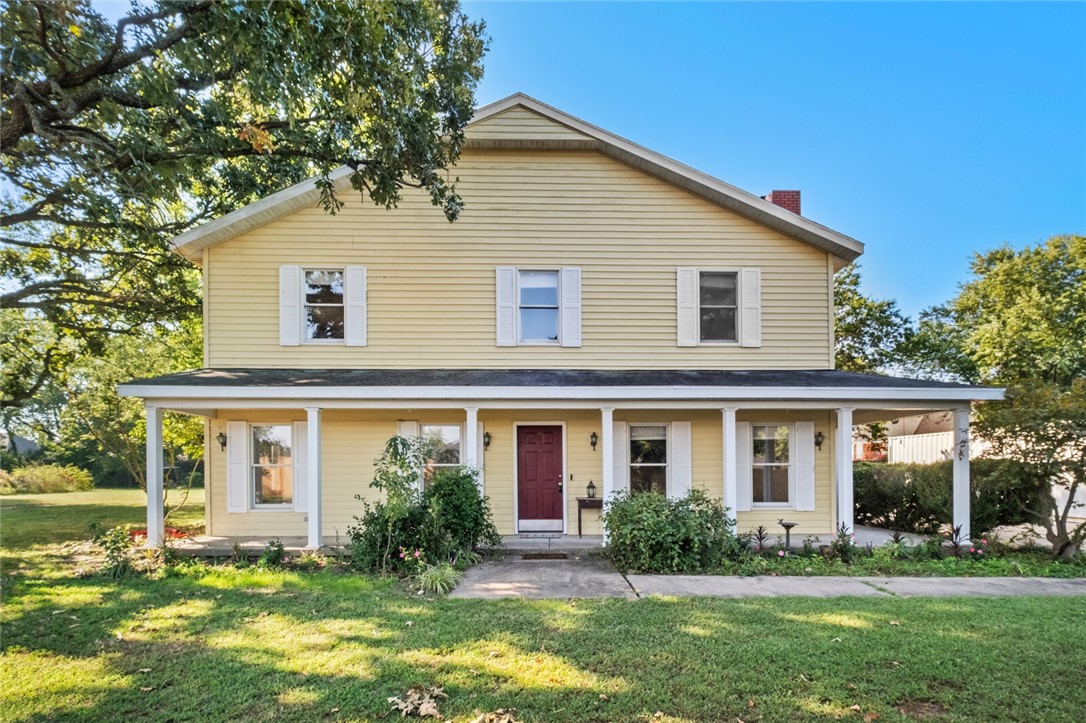 RARE FIND - 2 story farm style house with an inviting front porch on 2 (+/-) acres right in the middle of town! Spacious home with additional bonus room downstairs that could be a 4th bedroom, and a sunroom leading to the back patio. Close to everything Springdale has to offer. This could be a great place to start a hobby farm with several fruit trees on the premises, raise bees for honey, or use your imagination!