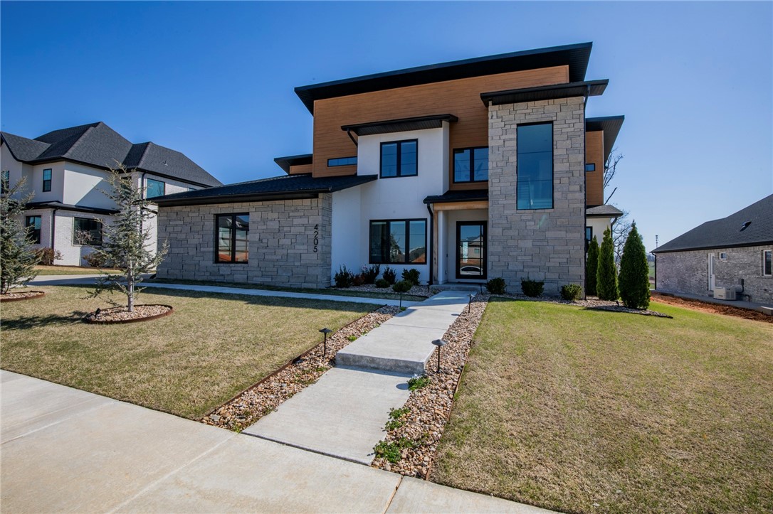 Custom built modern show stopper in Shadow Valley Gated Golf Community. Look no further as this home offers 4 bedrooms all with en-suites, half bath for your guest, wet bar for entertaining year around on the large patio with electric heaters and a breathtaking heated infinity pool. Bonus and full bath off the patio | pool area. The living space is modern and spacious and the chef's kitchen will not disappoint including large island with seating and an eat in kitchen. This includes racquet membership at the club along with yard and pool maintenance.