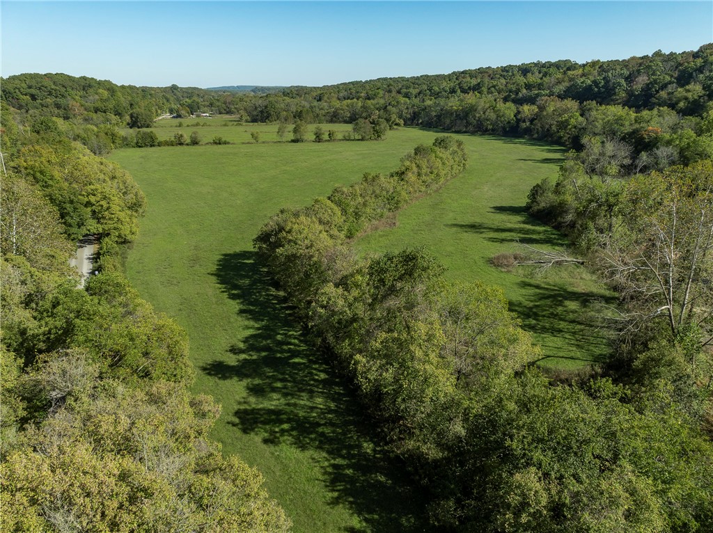 Discover your own slice of paradise on this 137.94 AC of beautiful property which features wooded areas, open pasture & Little Sugar Creek, creating an ideal setting for your dream home, cattle farm, or hunting getaway. Key Features are Road Frontage-Enjoy easy access w/road frontage on Sugar Creek Rd. Privacy & Seclusion -This wooded property offers a tranquil escape from the hustle and bustle, making it a perfect countryside retreat. Natural Amenities: Little Sugar Creek flows thru the property, enhancing the beauty of the landscape. Versatile Opportunities: With a mix of wooded areas, open pasture & pole shed, there are endless possibilities for development, recreation, or agriculture. Explore the nearby Pea Ridge Military Park, which offers fantastic mountain biking, horseback riding, hiking, &trail running opportunities. Donāt miss this unique chance to own a piece of serene countryside, rich w/natural beauty & potential. Perfectly situated, just 15 mins from Rogers and 30 mins from Bentonville.