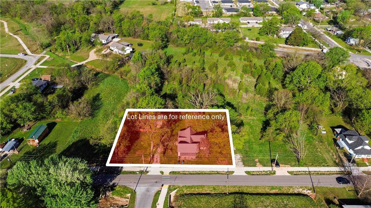 Aerial view of the property, highlighted in red, s