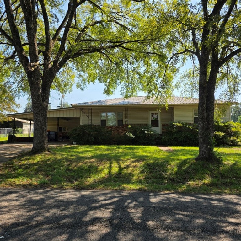 3 bedroom 1 bath home with 2 car attached carport plus a 2 car detached carport. Half acre corner lot offers room for gardening and other outdoor activities. It has a lean to behind attached garage and an outbuilding for storage and hobbies. It has a shaded front porch and front yard. The home has vinyl siding, metal roof, packaged HVAC unit, and newer vinyl windows. All offers to be submitted via Res.net by buyer's agent. Offers will be entertained after property has been exposed on the MLS for 7 calendar days.