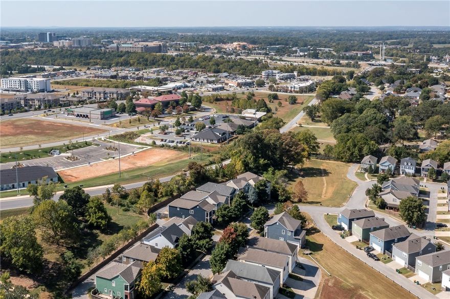 This Charleston Style Neighborhood is located in the HEART of Rogers.  Promenade mall, downtown Rogers, Bike Trails, I-49, Restaurants, Top Golf, The AMP, Wall-Mart home office and Mercy Hospital all with in minutes of this location. Four spacious bedrooms all upstairs.  Well laid out floor plan with 2 decks, one off of primary bedroom and the other deck off the kitchen area.  Bedrooms all with walk-in closets. Home has been painted thru out the inside, new carpet, new roof and HVAC all within the last four years. Come check out this fast growing area close to just about everything.  OWNER FINANCING AVAILABLE WITH ACCEPTABLE CONTRACT.