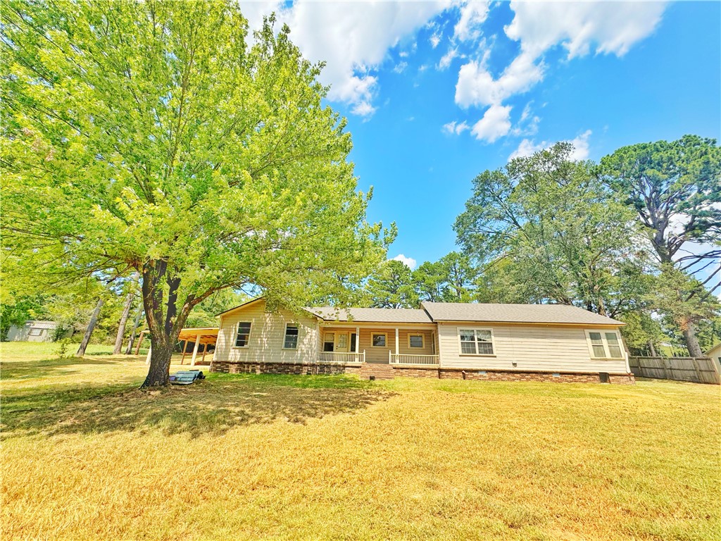 Spacious 3BR, 2BA home on 1.22 acres with a brand-new roof and original hardwood floors that are in great condition. Features a large covered patio, carport, and two storage outbuildings. Home still needs some more repair, but with a little love it could be a charming showstopper once again.