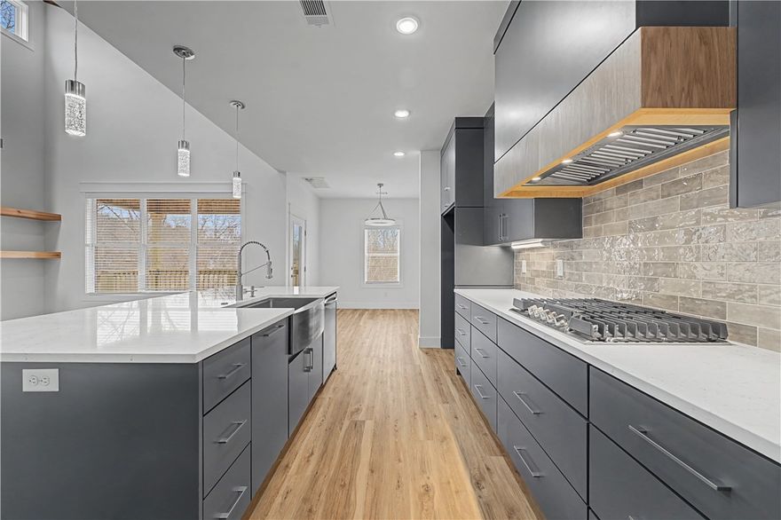 Welcome to this stunning new construction contemporary home, perfectly positioned on a spacious corner lot with peaceful views overlooking the woods.
Step inside to soaring cathedral ceilings highlighted by striking wood accents that add warmth and architectural character to the main living space. The open-concept layout seamlessly connects the living, dining, and kitchen area. 
The kitchen is a true showpiece, featuring sleek quartz countertops, abundant soft close cabinetry, and a pantry that combines beauty and functionality.
Designed with privacy in mind, the primary suite is thoughtfully separated from the secondary bedrooms and offers a luxurious ensuite bath created for relaxation and comfort. 
Dedicated office space and a versatile bonus room provides the perfect space for a workshop, hobby room, or bike storage.  For those who need extra space, the expansive crawl space offers storage.
All of this in a great location and all of Bella Vista's amenities. Seller is offering $2,500 in buyer concessions.