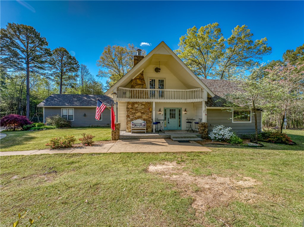 Charming & spacious retreat nestled just a short walk to Greers Ferry Lake in the serene Ozarks! This picturesque property on two parcels offers a perfect blend of country living & modern comforts. Enjoy the 3 bedrooms, 3 bathrooms, & ample space for both relaxation & entertaining. Enter to a bright & open floor plan that seamlessly connects the living, dining, & kitchen areas, with views of the surrounding outdoor beauty through every window! The cozy front room features a stone fireplace, perfect for those chilly evenings. Beautifully-updated kitchen has abundant storage. Two spacious, separated bedrooms with adjacent full bathrooms on the first level & one expansive bedroom with full bath + exterior balcony on the 2nd level. THREE water heaters! Great Room in rear of house has soaring ceilings, abundant windows & dual ceiling fans. Gorgeous landscaping around all sides, + yard irrigation system, backyard fire pit, & large detached garage building. Short walk to the nearest swimming/boat ramp on the lake!