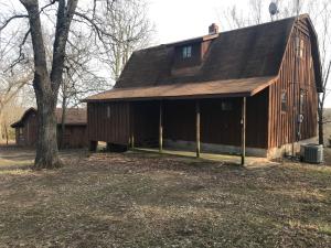 Private rustic country home on 7.5 acres M/L with 3 BR, 2 BA, covered porches, a partial walkout basement, paved road, CH&A replaced in 2013, and 14' x 16' storage barn. Sold AS IS.