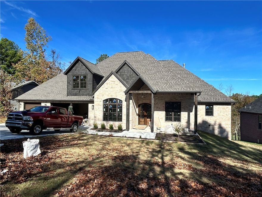 SOLD BEFORE PRINT.  Welcome to your dream home in Bella Vista! This newly constructed 3,089 sq ft modern masterpiece combines elegance and comfort on a lush .63-acre lot overlooking the Scotsdale Golf Course. The open, split-floor plan showcases premium features: a grand barrel ceiling entry, upgraded lighting, 7” European oak hardwoods, and expansive Windsor windows filling the space with natural light. A TimberTech deck creates a tranquil outdoor escape. Attention to detail shines with custom 3-step trim, Latham cabinets, and quartz countertops. The spa-like primary bath offers a marble shower and soaking tub, while guest bedrooms share a Jack & Jill bath. Visitors will love the elegant half-bath, and the 3-car garage (with epoxy flooring and a deep stall) completes this luxurious package. Bella Vista living at its finest awaits!