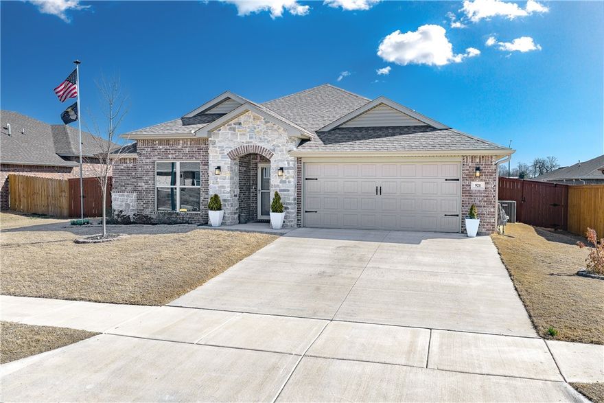Welcome to 921 S Green Heron Lane in Siloam Springs' sought-after Grandview Estates! This beautifully upgraded 2024-built traditional home offers 3 bedrooms, 2 bathrooms, and 1,734 sq ft of stylish, move-in-ready living. The brick and rock exterior leads inside to upgraded tile flooring in the living areas, granite countertops, and a kitchen showcasing an upgraded gas range and dishwasher. The primary suite features a luxuriously upgraded shower and walk-in closet. You'll love the whole-house generator, high-efficiency gas furnace, and energy-efficient tinted window coating throughout. The fully insulated, epoxy-floored 2-car garage is a standout bonus. Step outside to a covered patio, new wood privacy fence, three newly planted trees, and storm doors front and rear. Best of all, the transferable 2-year builder warranty (expires September 2026) and transferable 10-year structural warranty offer exceptional peace of mind. Schedule your showing today!