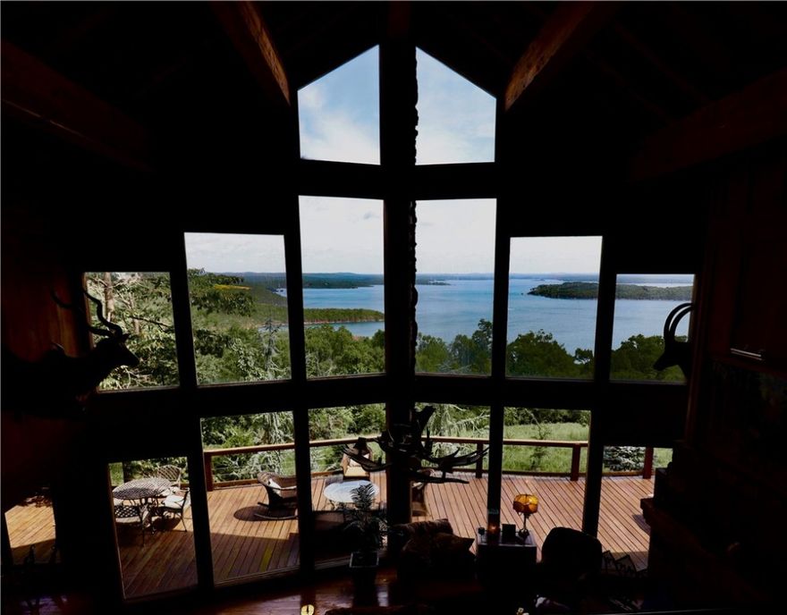 Bull Shoals lake house sitting on 33.04 +/- acres. Spread out and invite your friends to come enjoy the lake in your 5229 sq/ft home sitting on top of the mountain with astonishing views from almost every part of the house. One boat slip conveys in the community slip located just a short side by side ride and walk to the dock. Each floor has its own master bedroom which allows everyone to spread out and enjoy their time at the lake. The main floor consists of an open floor plan with large vaulting ceilings, rock fire place and unmatched views of Bull Shoals lake. Every inch of this house was carefully crafted with attention to all of the details. Enjoy campfires or soak in the hot tub on the patio. Lay out on the porch located on the main level and soak in the Vitamin D. Looking for recreation other than the lake? Enjoy trail riding or hunting on the 33.04 +/- acres of land. If you are looking to get away from the chaos of the world today this property will not disappoint. Bull Shoals lake totals 45,500 acres.