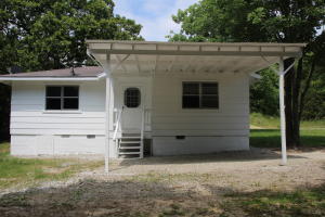 Newly remodeled two bed one bath home on the edge of town. This home has new paint inside and out with new flooring and fixtures. Large attached carport with wooded yard for privacy yet in the city limits. This one is move in ready and won't last long!