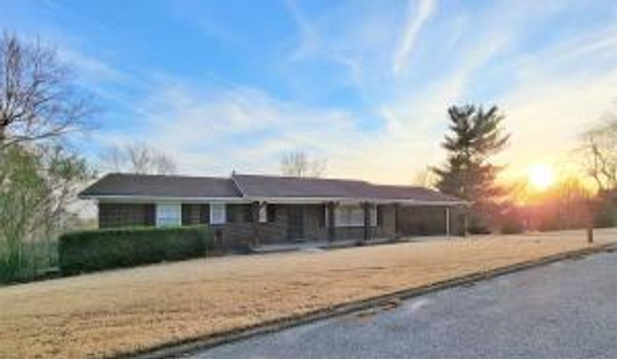 This immaculate home with full basement sits on 1 & 1/4 lots in a highly desired neighborhood. The home is brick exterior with rustic accents. Inside boasts a very modern feel with 4 bedrooms, 3 baths, real hardwood floors, a full walkout basement and crown molding throughout. This spacious house has over 2600 square feet with 1800 square feet on the main level and another 600+ square feet finished in the basement. The unfinished area of the basement provides ample room for workshop area and storage with another 800+ square feet. You'll love the covered front porch as well as a nice deck off the back. This is house is move in ready and is a must see!