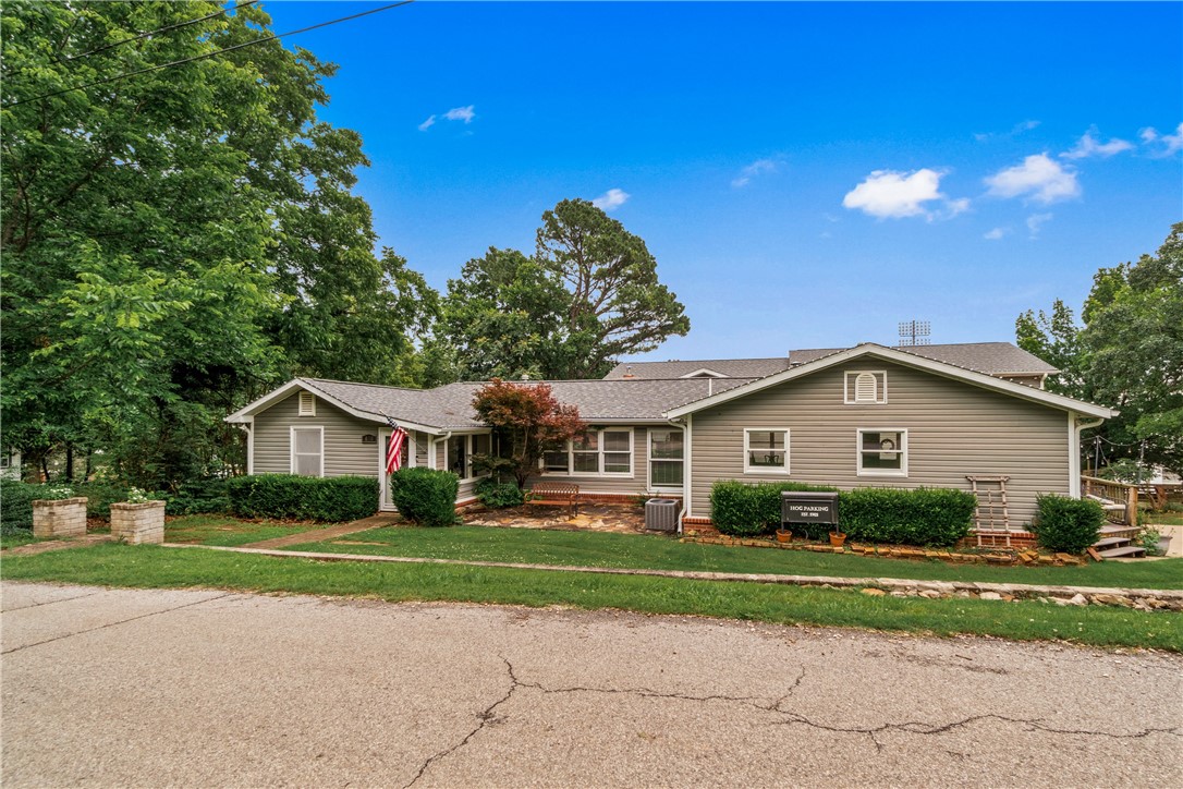 *Transferable Short Term Rental Permit*, Right across from Razorback Stadium, this iconic game-day spot is one of the most recognized homes in Fayetteville—known for its unbeatable location and legendary gatherings. Remodeled and expanded in 2013, the home features 7 bedrooms, 6 bathrooms, 2 kitchens, and a massive 42' x 25' game/media room, built with entertaining in mind. Three of the bedrooms are private ensuites, offering space and flexibility. The landscaped yard is wired with electric and cable, and even the two-story treehouse is outfitted with TV mounts, power, and WiFi. Two home-based businesses may convey with the sale at the seller's discretion. Driveway is shared with 400 N Oliver.