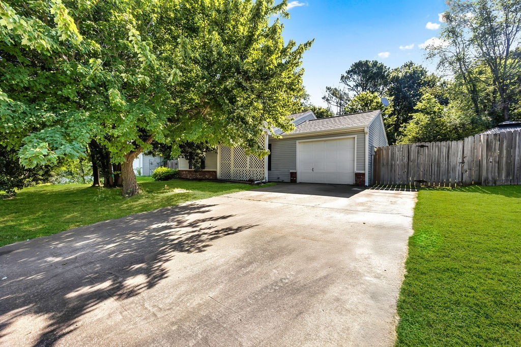 Adorable home in the Woodfield Subdivision! Functionality for the whole family, with open layout. Wonderful living space with vaulted ceilings and wood-burning fireplace, creating wonderful space to relax with family. Charming eat-in kitchen offers new electric range and dishwasher. Recently updated with fresh paint, countertops and fixtures. New roof was replaced in 2017. Outbuilding is ideal for additional storage and garden shed. Perfectly situated less than 10 minutes away from the University of Arkansas. Located in a established and friendly neighborhood with convenient access to shopping, dining, trails and I-49. Move in ready and waiting for you!