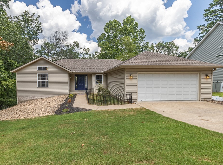Great 4Br, 3Ba home with an awesome media room! Main level: Split floor plan. Living room with a remote-controlled gas log insert, installed in 2023. Eat-in kitchen with new appliances in 2021, laminate flooring in 2022, pantry w/adjustable shelves. Primary bedroom & ensuite bath with a walk-in shower & walk-in closet. 2nd & 3rd bedroom with a full bath between. Laundry room with a cool antique dresser sink base. Cover deck with a ceiling fan to sit & enjoy your morning coffee! Lower level: Kitchennette area with a large pantry that has adjustable shelves, bedroom, full bath, super cool media room with projection screen & leather reclining theater seats! Patio. Lower level is great for an extended family member's living space. Crawlspace fully encapsulated with a dehumidifier in 2022! Exterior: New front landscaping. Backyard is partially fenced. Garage has a gas space heater. Located close to Lake Norwood & Country Club golf course! Adjoining lot available for an additional 15K! Full improvements list available.