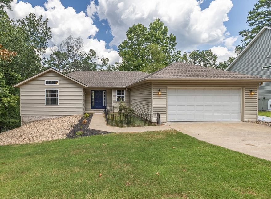 Great 4Br, 3Ba home with an awesome media room! Main level: Split floor plan. Living room with a remote-controlled gas log insert, installed in 2023. Eat-in kitchen with new appliances in 2021, laminate flooring in 2022, pantry w/adjustable shelves. Primary bedroom & ensuite bath with a walk-in shower & walk-in closet. 2nd & 3rd bedroom with a full bath between. Laundry room with a cool antique dresser sink base. Cover deck with a ceiling fan to sit & enjoy your morning coffee! Lower level: Kitchennette area with a large pantry that has adjustable shelves, bedroom, full bath, super cool media room with projection screen & leather reclining theater seats! Patio. Lower level is great for an extended family member's living space. Crawlspace fully encapsulated with a dehumidifier in 2022!  Exterior: New front landscaping. Backyard is partially fenced. Garage has a gas space heater. Located close to Lake Norwood & Country Club golf course! Adjoining lot available for an additional 15K! Full improvements list available.