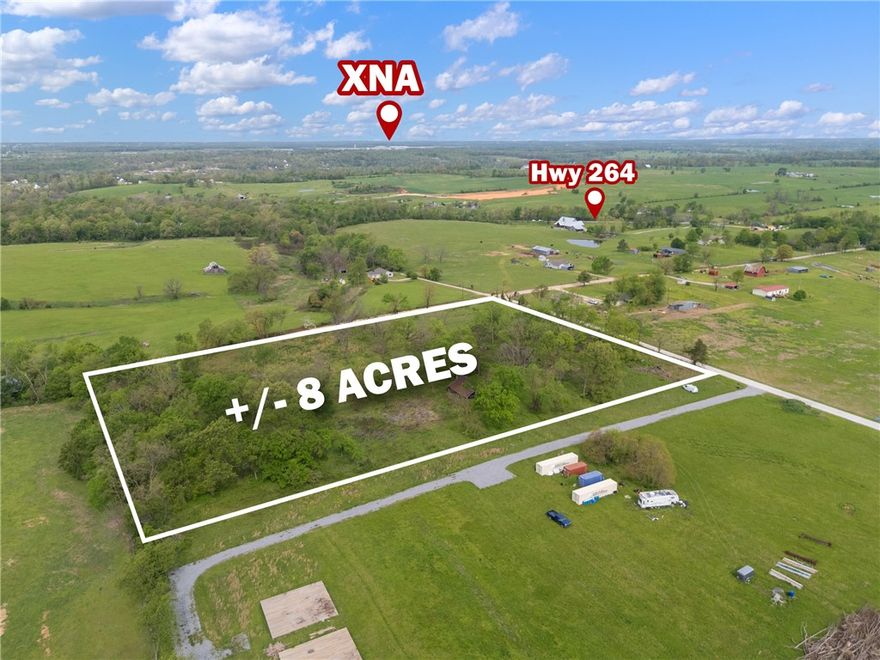 +/- 8 acres of land available just outside city limits, offering the perfect opportunity to build your dream home, start a hobby farm, or simply enjoy peaceful country living. This prime location is less than 9 minutes from XNA, only 5 minutes from The Creeks Golf Course, and situated just a half mile from Highway 264, providing convenient access to nearby amenities. Located within the highly sought-after Bentonville School District, this property combines rural charm with top-tier educational opportunities. Electric service is available at the street, while a septic system and water well will be needed. The house currently on the property is set to be removed.