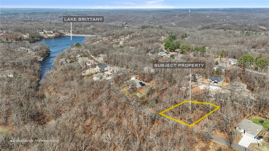 Great building lot just a block away from Lake Brittany.  Nice neighborhood in Bentonville School District. Get it before it's gone!  No current perc or survey available.