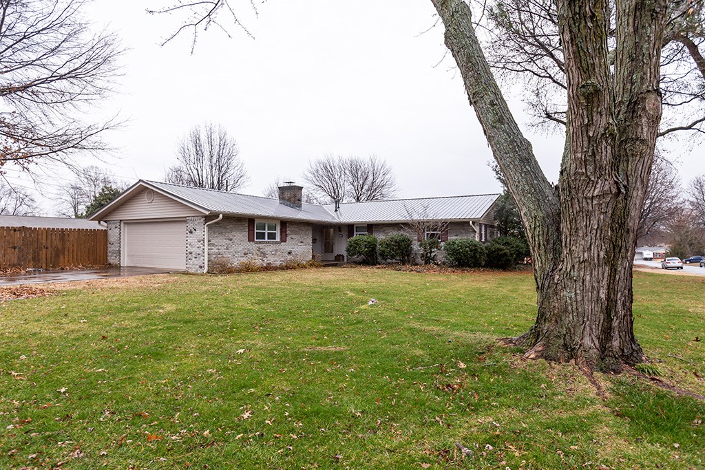 Charming Family home that's been well taken care of and loved for 44 years by this family. Great layout with a large family room (bamboo flooring) that completes the open concept. Darling curved brick wood burning fireplace with gas starter in hearth room currently used as dinning area.. New Metal Roof added 2012, Dishwasher 2012, Furnace 2003, Interior Paint 2015. This Home is on a large corner lot with majestic trees nestled in established quiet neighborhood. Great fenced back yard with a precious partially covered back patio that is great for grilling and outdoor entertaining. Wonderful Attic Fan that home owner loves and uses in Spring, Summer and Fall. Don't miss the 575 Sq Ft covered storage area on East side of home and the doggie door in the side door from garage to back yard. The Washer and Dryer are in the garage but boasts an independent gas heater to keep environment pleasant during cold winter months. Work Bench in garage will convey.