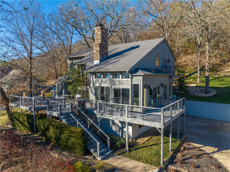 Dramatic Contemporary home on large wooded lot on South Side of Mount Sequoyah, well located with panoramic views of the mountains. May updates in this open floor plan with large windows and lots of natural light. Perfect for entertaining inside and out with over 1,000 sq ft of deck, views to the front and privacy and woods in the back. Wood floors throughout, dramatic wood burning stone fireplace, vaulted ceilings, large loft area with multiple uses. Open kitchen with breakfast nook, large formal dining, living room opens to office. 3 BR and 3 baths. Enormous amount of storage on garage level and a heated and cooled option room.