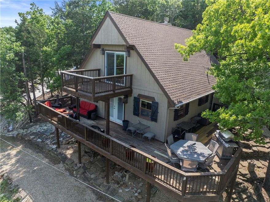 BOAT SLIP INCLUDED + EXTRA LOT!
Turnkey, fully furnished lake retreat in Lost Bridge Village with stunning winter lake views and seasonal summer views—ready for immediate enjoyment or short-term rental income. Ultimate lake lifestyle with warm, lodge-inspired finishes including exposed wood beams, rich walnut floors, and wood-look tile throughout. The private top-floor primary suite offers a peaceful escape with serene views, soaking tub, and walk-in shower. Designed for gathering and entertaining, the walk-out basement features a cozy fireplace, game area, and additional sleeping space—ideal for hosting guests or maximizing rental potential. Step outside and enjoy everything this amenity-rich community has to offer: swimming pool, tennis courts, clubhouse, fitness center, and even a private airstrip. Recent updates include a newer roof and HVAC (approx. 2 years old). The included extra lot provides rare flexibility to build a garage, guest house, or expand your investment. This one checks every box!