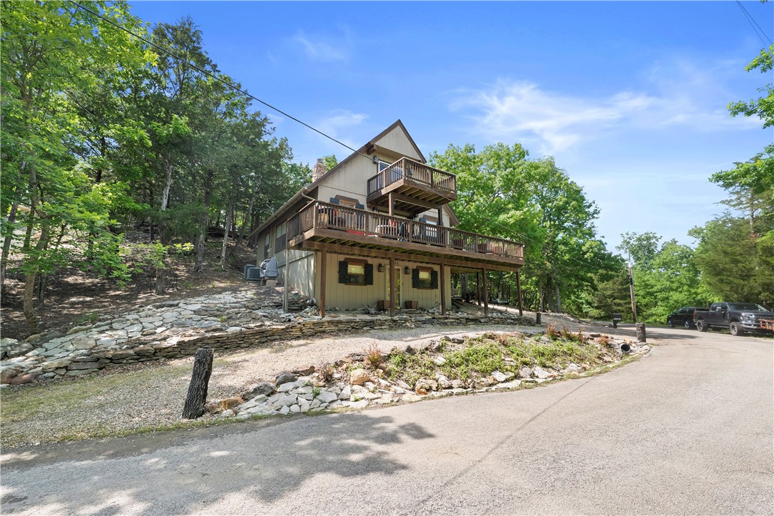 Turnkey furnished lake home in Lost Bridge with stunning full winter lake views and partial summer views! This 3-level, 4BR/3BA home is move in or short-term rental ready and features wood beams, wood-look tile, and beautiful walnut floors, these beautiful wood elements throughout create a warm, lodge-like atmosphere. The private top-floor primary suite includes a soaking tub, walk-in shower, and serene views. The spacious walk-out basement offers a cozy fireplace, game area, and 2 bedrooms (no windows). Includes a boat slip & 26' Dunzi ski boat negotiable . Roof and one HVAC unit are just 2 years old. An extra lot is includedāperfect for building a garage or second home. Enjoy resort-style amenities: swimming pool, tennis courts, clubhouse, fitness center, and a private airstrip. Ideal for lake living or investment, this fully furnished home is move-in ready with everything in place. Whether you're looking for a weekend retreat or a high-demand rental, this property offers it all in a premier lake community.