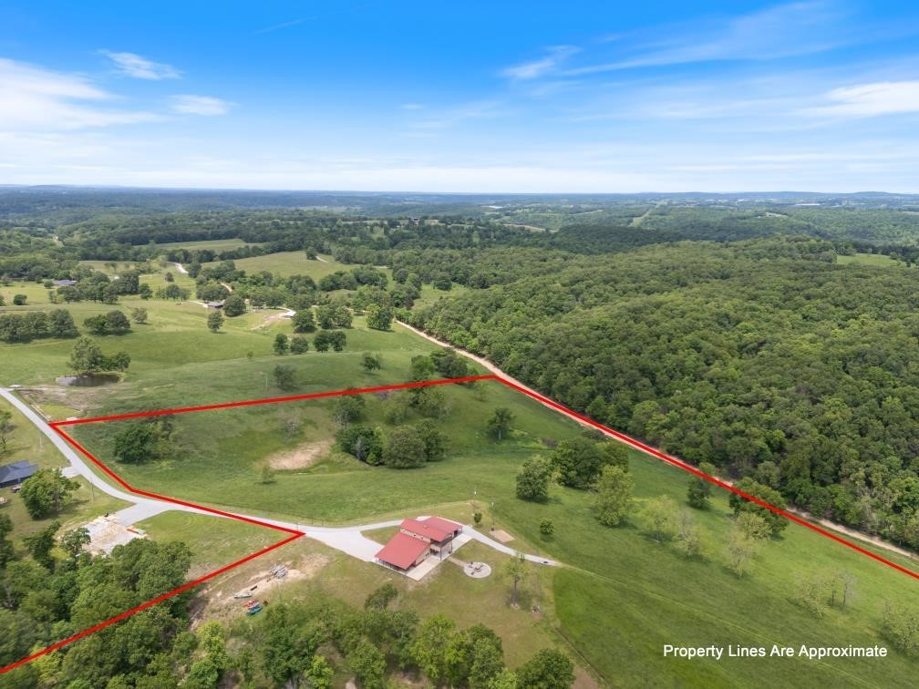 Welcome to your private retreat on 73.91±/- acres with War Eagle Creek frontage. This 3 bed, 2.5 bath home sits at the end of a paved road, offering peace, privacy, and stunning sunset views. Inside, warm woodwork flows throughout, creating a cozy, timeless feel. The spacious master suite includes a huge walk-in closet, and the covered back deck is perfect for relaxing or entertaining. Enjoy canoeing, fishing, or simply unwinding by the creek on your own land. Whether you’re looking for a family getaway, weekend retreat, or forever home, this unique property blends natural beauty with comfort and space to roam.