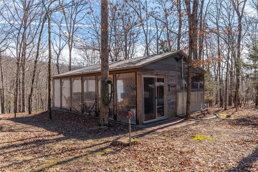 Escape to 16+ beautiful acres tucked away in the heart of Crawford County between Alma and Fayetteville, offering a true slice of country paradise. Serene surroundings, mature trees, a creek, bluffs, and an abundance of wildlife! Deer, turkey, fox, and other small game are frequently seen on the property. Modern utilities include electric, city water, and fiber internet make the 20x30 "glamping" pavilion comfortable for families, hunters, hikers, and riders. The pavilion features a full bathroom with a tankless water heater, a kitchenette with a sink and fridge, and a wood burning stove. In cool weather, an insulated ceiling and clear vinyl panels retain the heat, yet allows you to enjoy the views. In warm weather, take the vinyl panels down to enjoy the breeze coming up the valley from the creek. The RV pad facilitates convenient access to the amenities of the pavilion. Conveniently located near the Buckhorn Trail system, it is ideally situated as a place to stay while enjoying your side-by-side.