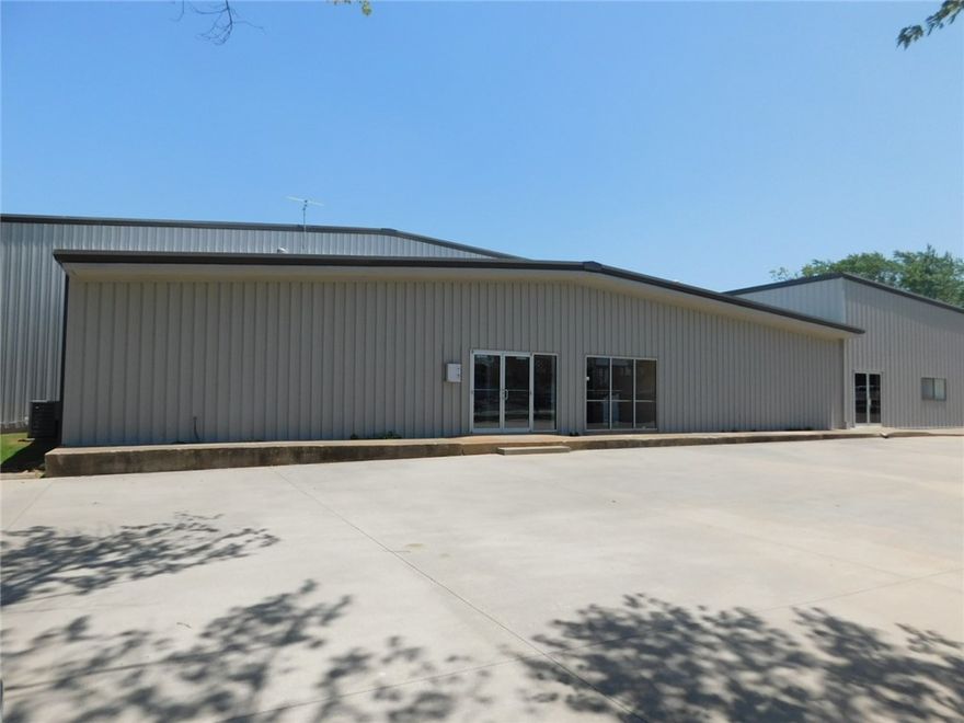 Warehouse, office, storage or distribution space located in an industrial area of Rogers close to I-49. Land is 2.3 acres. Level, fenced, secured back lot with 2 entrances/exits. Appx 2,500 sq. ft. office. Completely redone, new roof, new HVAC, paint, flooring. 18' side walls with 2 drive-thru doors 16' and 14'. Lots and lots of possibilities. Currently being used as construction office/warehouse.