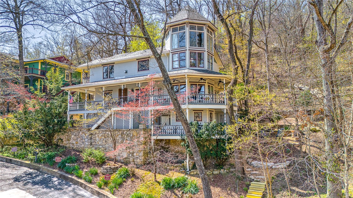 Welcome to the Top-Rated Arsenic and Old Lace. This lodging property is a REPEAT MEDAL WINNER OF Best of NWA, including BEST Lodging, BEST Romantic Getaway & BEST B&B. This highly profitable property has a loyal customer base & impressive financial performance. Combined with a newly updated & private innkeeper's quarters, it's set up for long term success & solid return on investment for new owners.
Lavish & welcoming with 5 guest suites, each with carefully remodeled bathrooms. Your guests will enjoy the bright & comfortable eating area with lovely fireplace, perfect for breakfast and gathering. Stunning back living area has direct access to the Spring Garden Trail, which provides an easy walk to downtown! Tesla car chargers(only ones in Eureka Springs) and trolley stop, provide superior convenience too! This would also make an incredible family home! Space for all & incredible experience living in Eureka Springs! Being sold furnished. Located in one of the top vacation destinations in Arkansas!