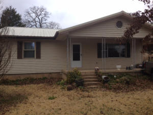 GREAT VALUE! Nice 2 BR, 1 bath home walking distance to the lake & Lead Hill School. Lg living room, a nice kitchen/dining combo, small bar for 2 & lg utility room. Kitchen cabinets made specifically for this house. There's (1) enclosed seperate garage, (1) portable shed and (2) carports. Several mature trees & lots of fruit trees. Has fireplace, heat pump & propane heat!!! A must to see!